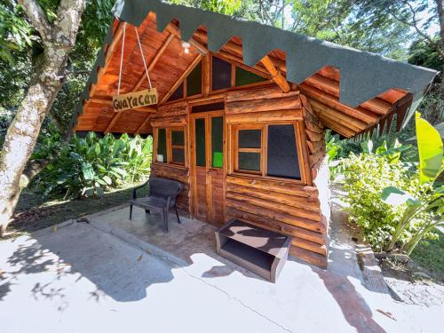 a small wooden house with a chair in front of it at Solvae EcoHotel in San Jerónimo