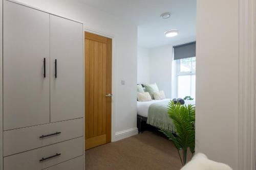 a bedroom with a bed and a dresser at St James Court Aparthotel in Derby