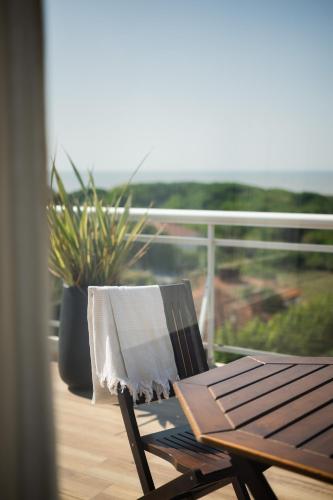 a towel sitting on a chair on a balcony at Terrazas Ostende - Apart Hotel in Ostende