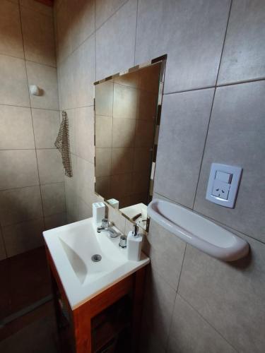 a bathroom with a sink and a mirror at Cabañas a 5 minutos del río in Alta Gracia