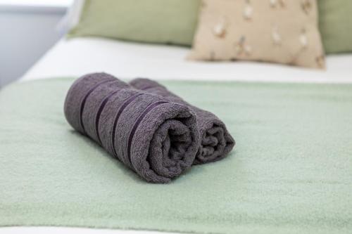 a purple towel laying on a bed at St James Court Aparthotel in Derby