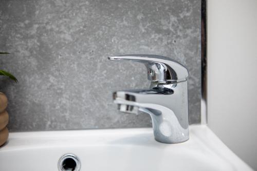 a bathroom sink with a silver faucet at St James Court Aparthotel in Derby