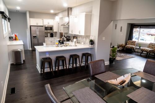 a kitchen and living room with a table and chairs at Modern 3BDRM, Renovated, Spacious & Central in Evansville