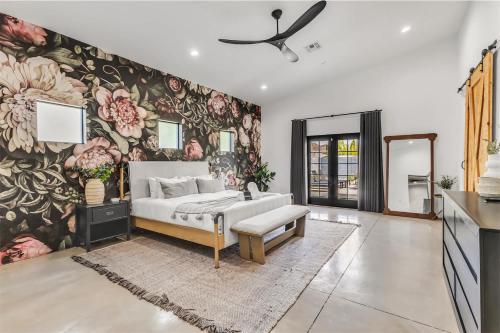 a bedroom with a bed and a floral wall at Modern Industrial-Near Old Town in Scottsdale