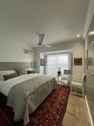 a bedroom with a large bed and a window at Somerset West Garden Apartments 4 in Somerset West