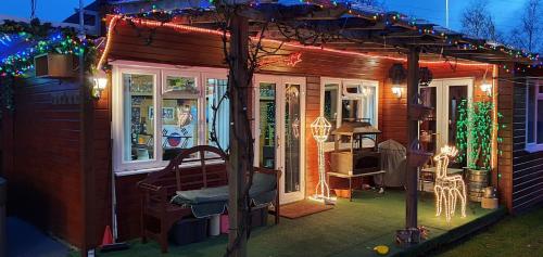 a small house with christmas lights on it at Dorset Escape in Poole