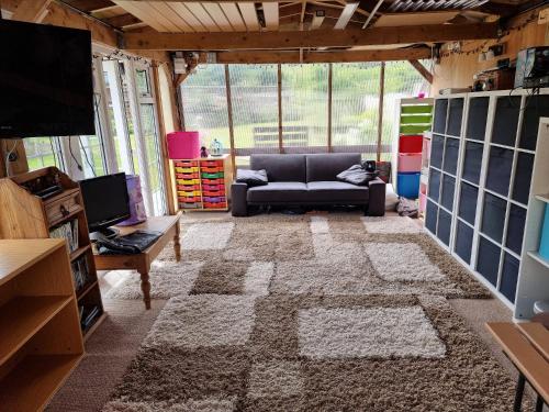 a living room with a couch and a television at Dorset Escape in Poole