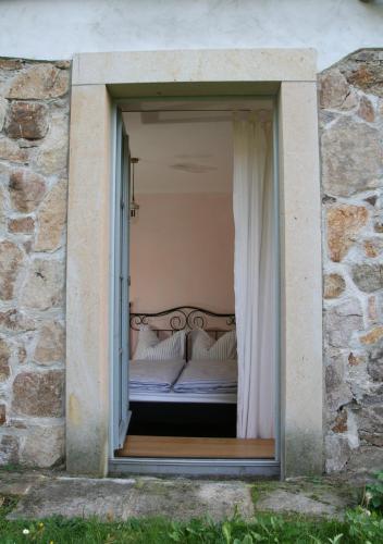 a bed in a window in a stone building at Schlossmühle Schieritz in der Nähe von Meißen in Schieritz