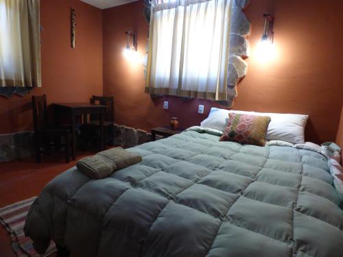 a bedroom with a large bed in a room at Lodge Mirador San Antonio- Colca in Coporaque