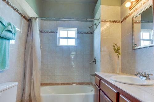 a bathroom with a tub and a sink and a bath tubermottermott at View the Blue -Upper Level -Gold Standard Certified in Cayo Romero