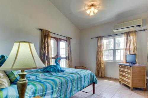 a bedroom with a bed with a lamp and a desk at View the Blue -Upper Level -Gold Standard Certified in Cayo Romero