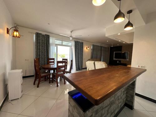 een keuken en woonkamer met een tafel en stoelen bij Nyumba Alfajiry in Malindi