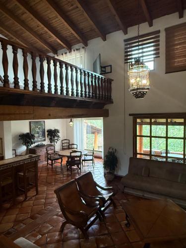 a living room with a couch and a table at Tapalpa Country Club Hotel in Tapalpa