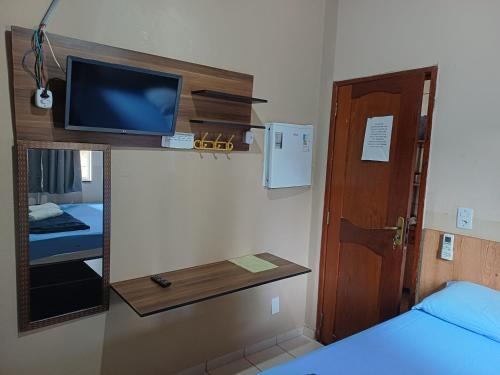 a room with a bed and a tv and a mirror at Casa da Família Carvalho - 986 in Belém