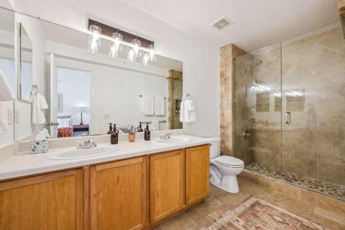 a bathroom with a sink and a shower and a toilet at 3BR Modern Retreat, Close to DIA & Downtown Denver in Commerce City