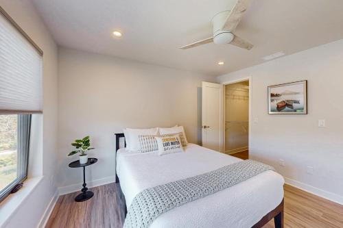 a bedroom with a bed and a ceiling fan at Lake George Getaway in Lake George