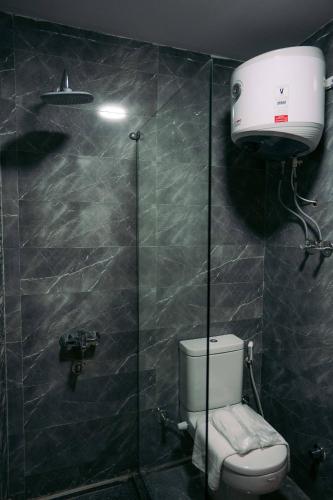 a bathroom with a toilet and a shower stall at Florya pyramids hotel in Cairo