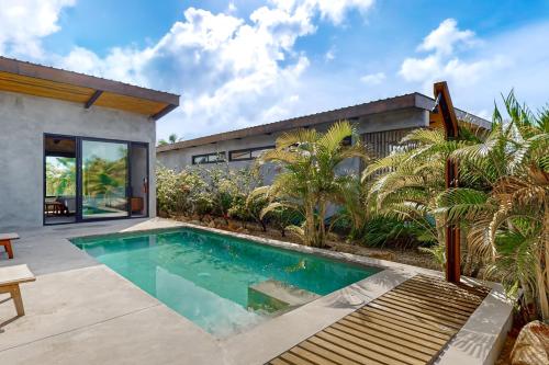 a swimming pool in the backyard of a house at Seabird - Villa 20 in Placencia Village