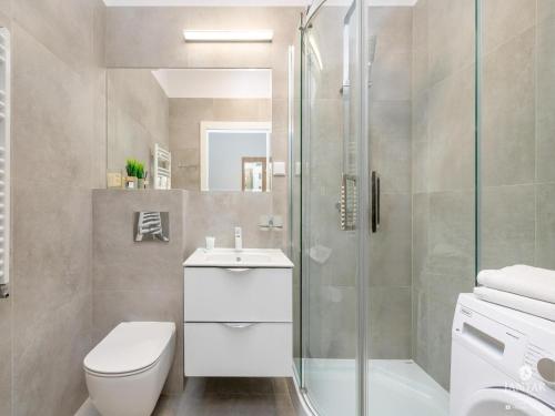 a bathroom with a shower and a toilet and a sink at Apartment in Pobierowo near Baltic Beach in Pobierowo