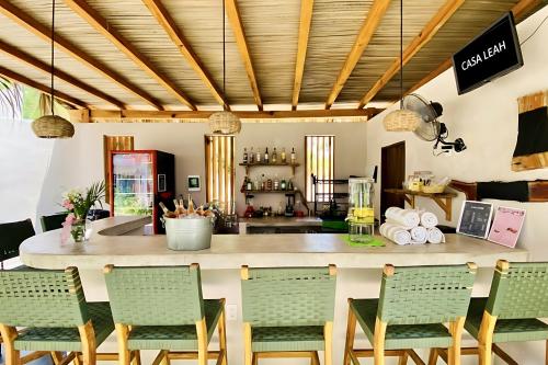 a kitchen and dining room with a counter and chairs at Casa Leah Puerto Escondido in Puerto Escondido