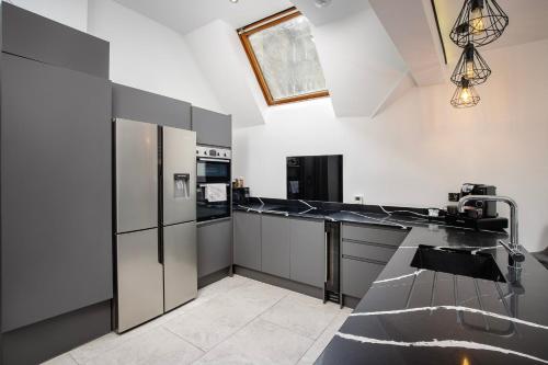 a kitchen with stainless steel appliances and black counter tops at Luxury royal mile boutique 2bedroom apartment in Edinburgh