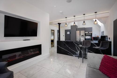 a living room with a fireplace and a flat screen tv at Luxury royal mile boutique 2bedroom apartment in Edinburgh