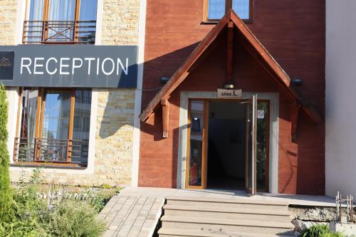 a building with a sign that reads reception at Apartman TAUNUS in Kopaonik