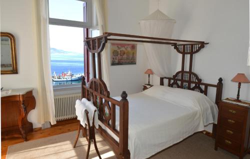 a bedroom with a bed and a large window at V. Molova, Molyvos, Lesvos in Mithymna