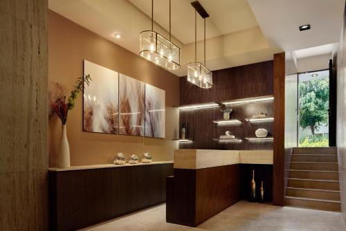 a lobby with a staircase and a sink and lights at Felix by Viadora in Mexico City