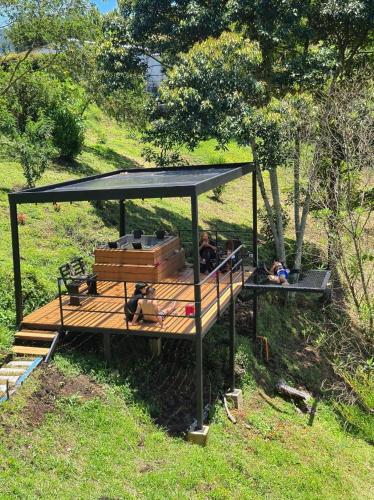 a group of people sitting on a wooden deck at Cabina con Jacuzzi cerca al Peñol in Chiquinquirá