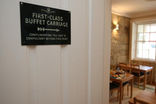 a first class buffet carriage sign hanging on a wall at Fishtail Sea House in Matosinhos