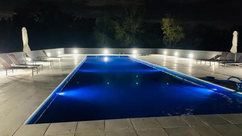 a swimming pool at night with blue illumination at G&A Rent, cerca de Aeropuerto Ezeiza in Ezeiza