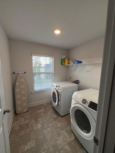 a laundry room with a washing machine and a washer at Conyers Place in Conyers