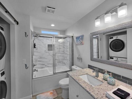 a bathroom with a shower and a toilet and a sink at Pooldreamz! Beachfront Heated Salt Pool! Sleep24! in Caplen