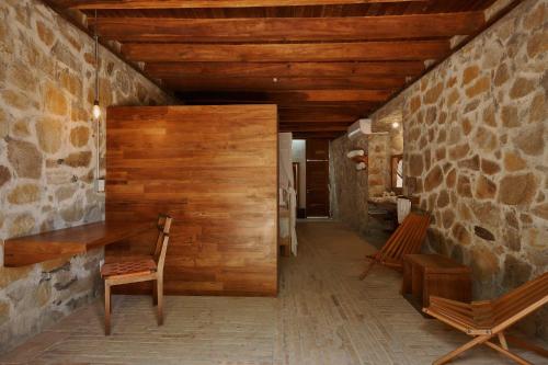 a hallway with wooden walls and a stone wall at Casa del Mar AC Rustic design Pool Paceful in Santa María Tonameca