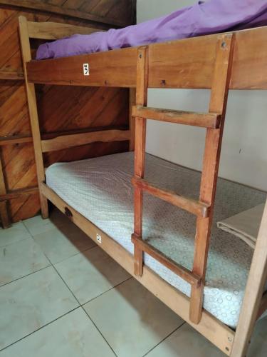 a bunk bed with two ladder bunk beds in a room at Iguana Hostel in Montañita
