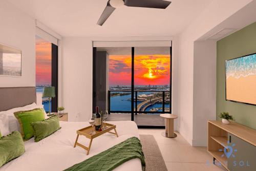 a living room with a couch and a large window at Luxury Apartment 3 Bedrooms Pool Gym Views & More in Miami