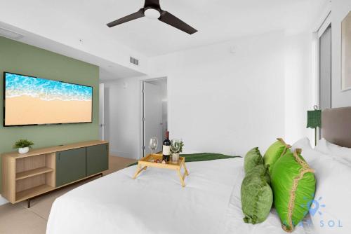 a living room with a large bed and a flat screen tv at Luxury Apartment 3 Bedrooms Pool Gym Views & More in Miami