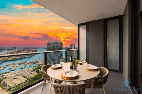 a dining room with a view of the ocean at Luxury Apartment 3 Bedrooms Pool Gym Views & More in Miami