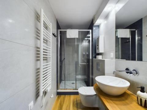 a bathroom with a white sink and a shower at Apartamenty Familly Dąbrówka - przy parku, prywatny parking, sauna, ogód - by SpaceApart in Jelenia Góra