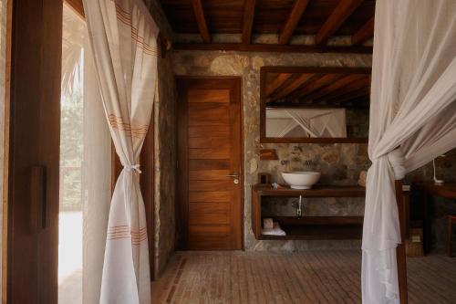 a room with a doorway with a curtain and a sink at Casa del Mar AC Rustic design Pool Paceful in Santa María Tonameca