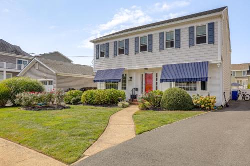 a white house with a red door and a driveway at Walk to Beach! Point Pleasant Home with Heated Pool in Point Pleasant Beach