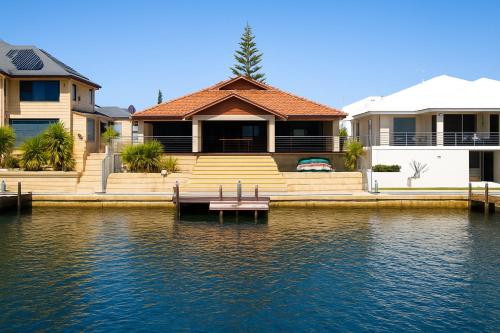 a house with a dock in front of the water at Panda Living waterfront paradise in Wannanup