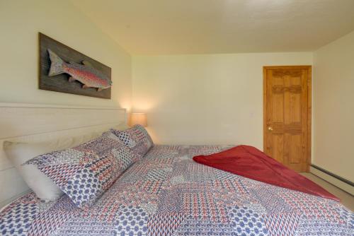 a bedroom with a bed with two pillows on it at Walk to Lake Winnisquam Access Cozy Retreat in Winnisquam