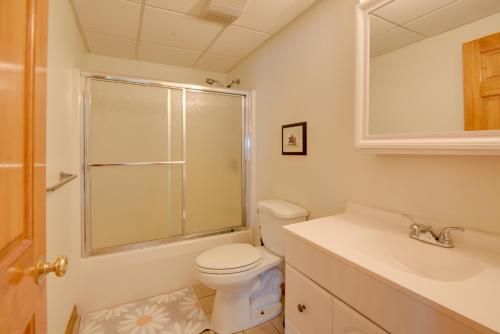 a white bathroom with a toilet and a sink at Walk to Lake Winnisquam Access Cozy Retreat in Winnisquam