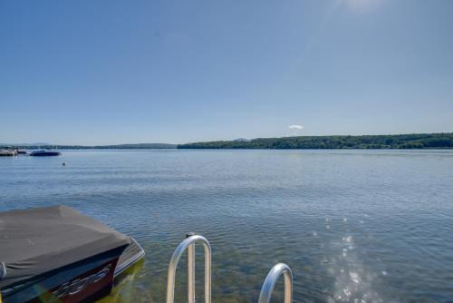 a boat is docked on a large body of water at Walk to Lake Winnisquam Access Cozy Retreat in Winnisquam