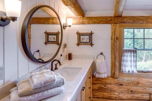 a bathroom with a sink and a mirror at Cozy Log Cabin Near Mt Snow Views, Modern Comfort in Wilmington
