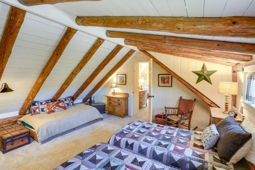 a attic bedroom with a bed and a chair at Cozy Log Cabin Near Mt Snow Views, Modern Comfort in Wilmington