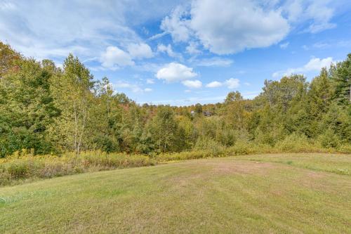 an open field with trees in the background at Cozy Log Cabin Near Mt Snow Views, Modern Comfort in Wilmington