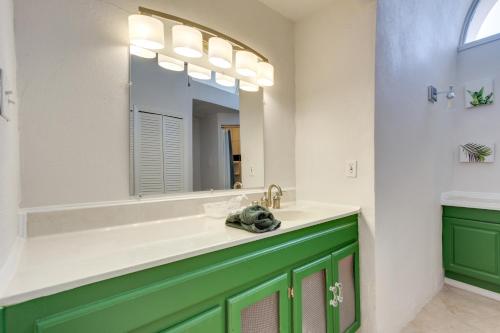 a bathroom with a green vanity and a mirror at Walk to Beach Unique Family Gem in Pass Christian in Long Beach